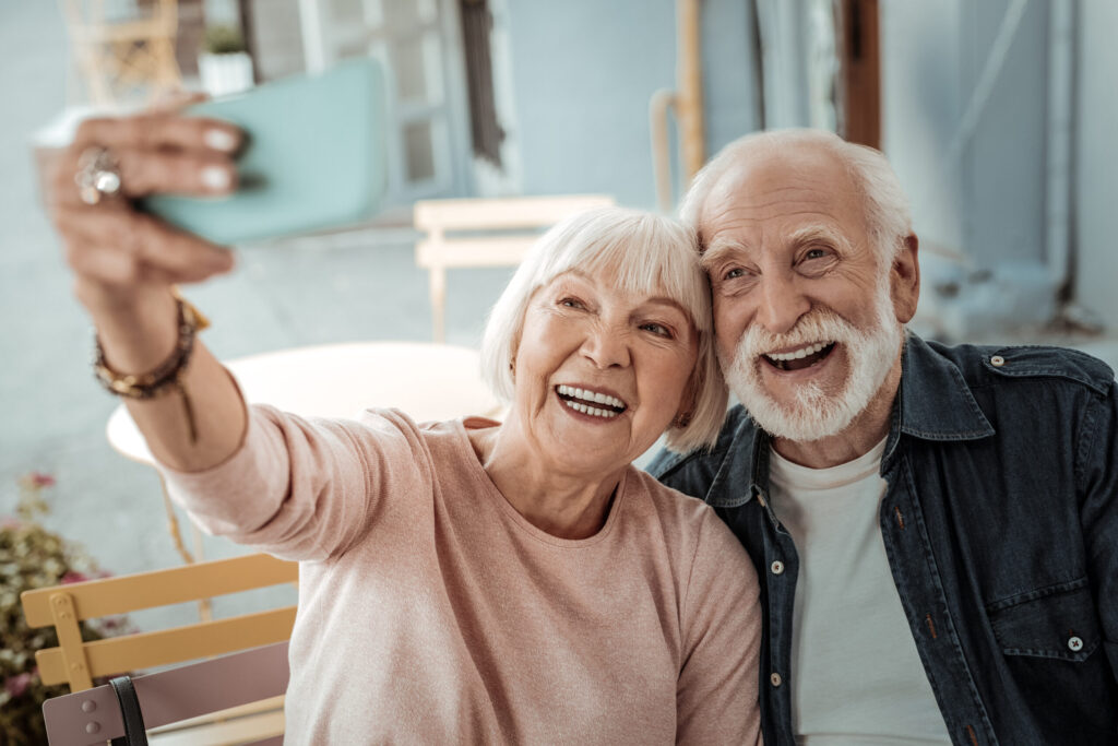 Happy aged couple taking a selfie together